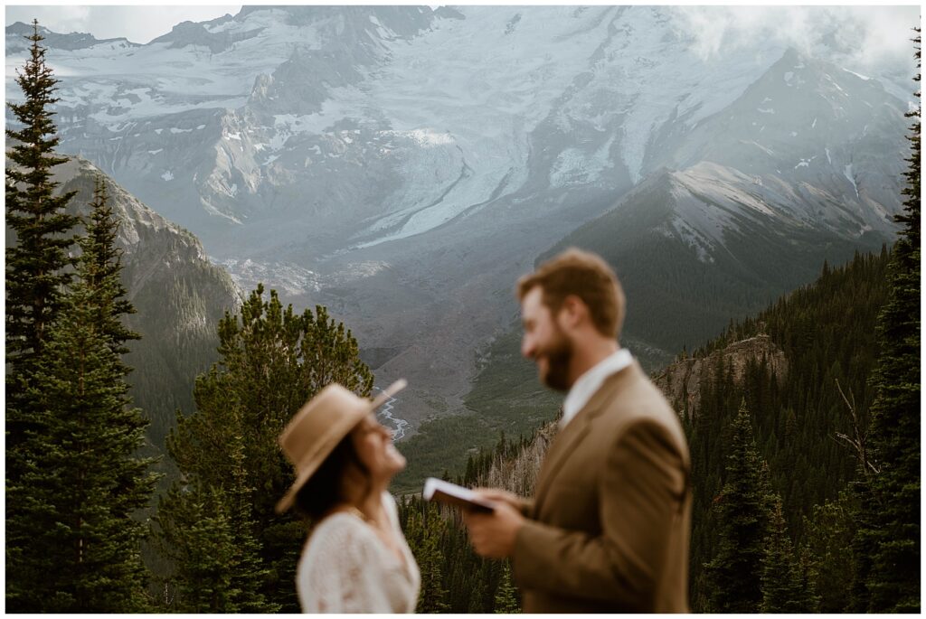 Couple exchanging vows with Mount Rainier in the background